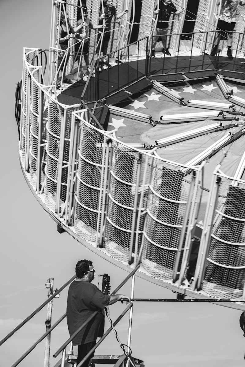 A man taking a picture of a ferris wheel